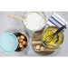 Mixing eggs and wheat flour in the stainless steel mixing bowls