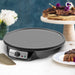 Elite Gourmet Nonstick Electric Crepe Maker & Griddle on the table with cakes.