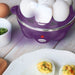 Egg cooker power indicator light is lit red. Plate of deviled eggs next to egg cooker.