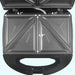 Cooking plate view with measurements. Makes four triangle sandwiches at a time. Sandwich sized 4.1 inches by 4.9 inches. 
