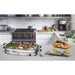 Buffet Server on kitchen counter next to plates and serving utensils.