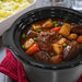 Removable stoneware slides right out of the base for easy transport to the table or storage in the fridge. Showing Elite Gourmet Slow Cooker's stoneware part with curry.