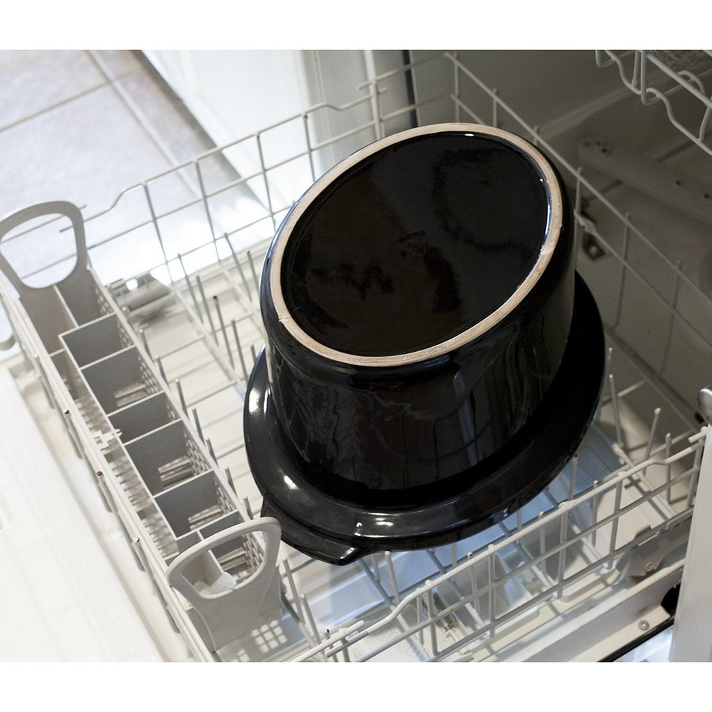 Inner ceramic pot placed inside a dishwasher rack.